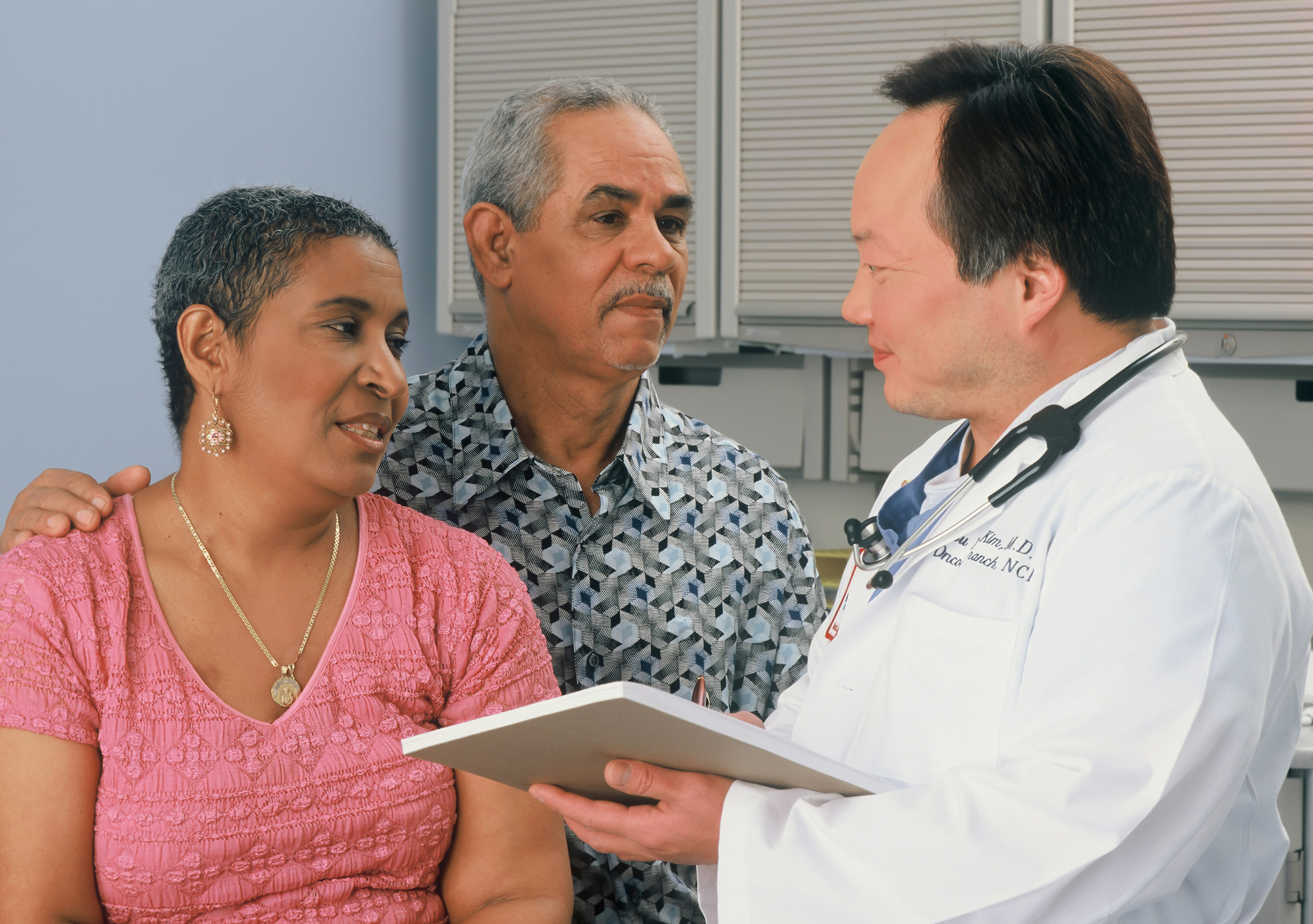 An older couple speaks with their doctor