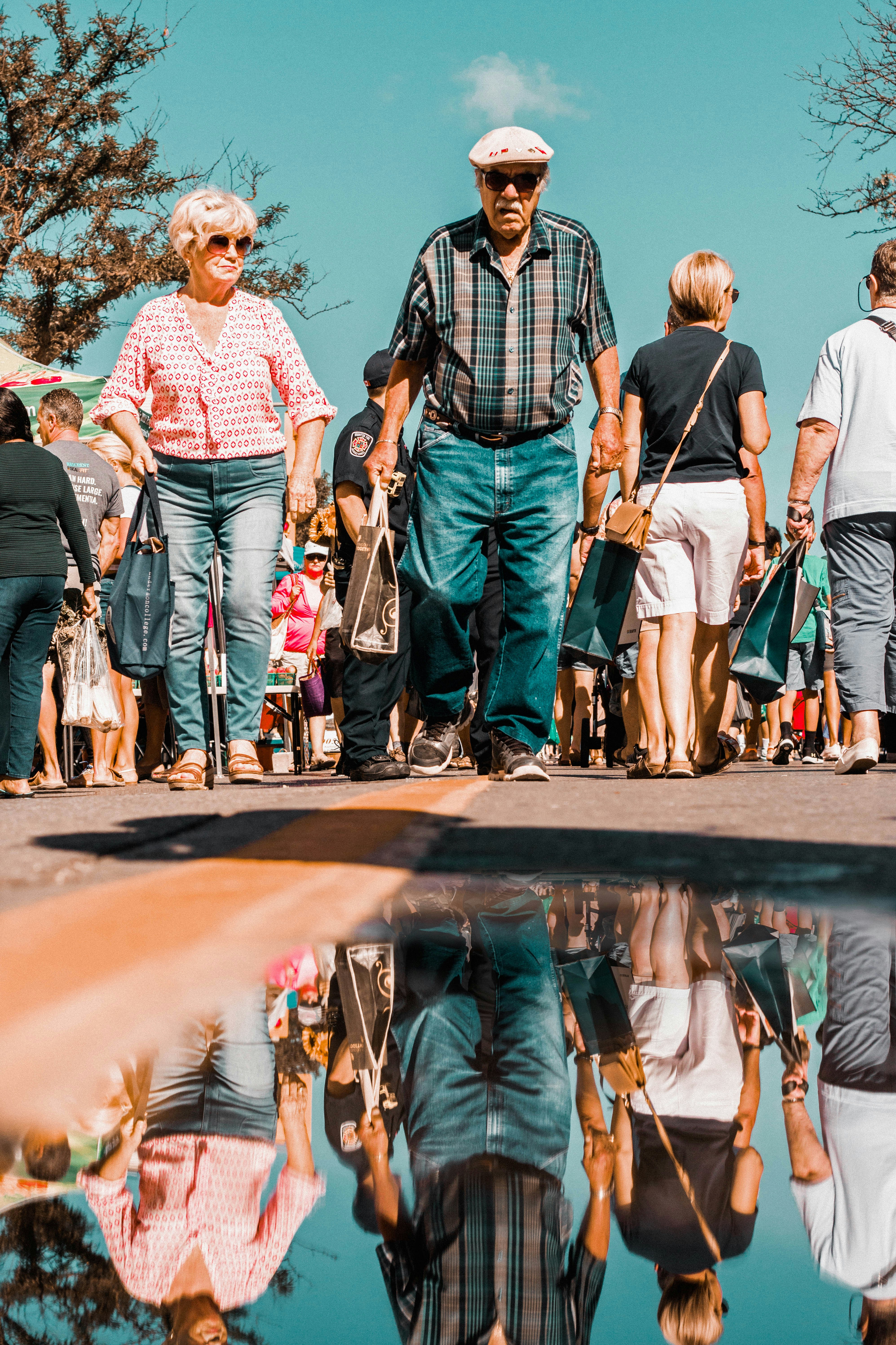 An older couple walking together at an outdoor market