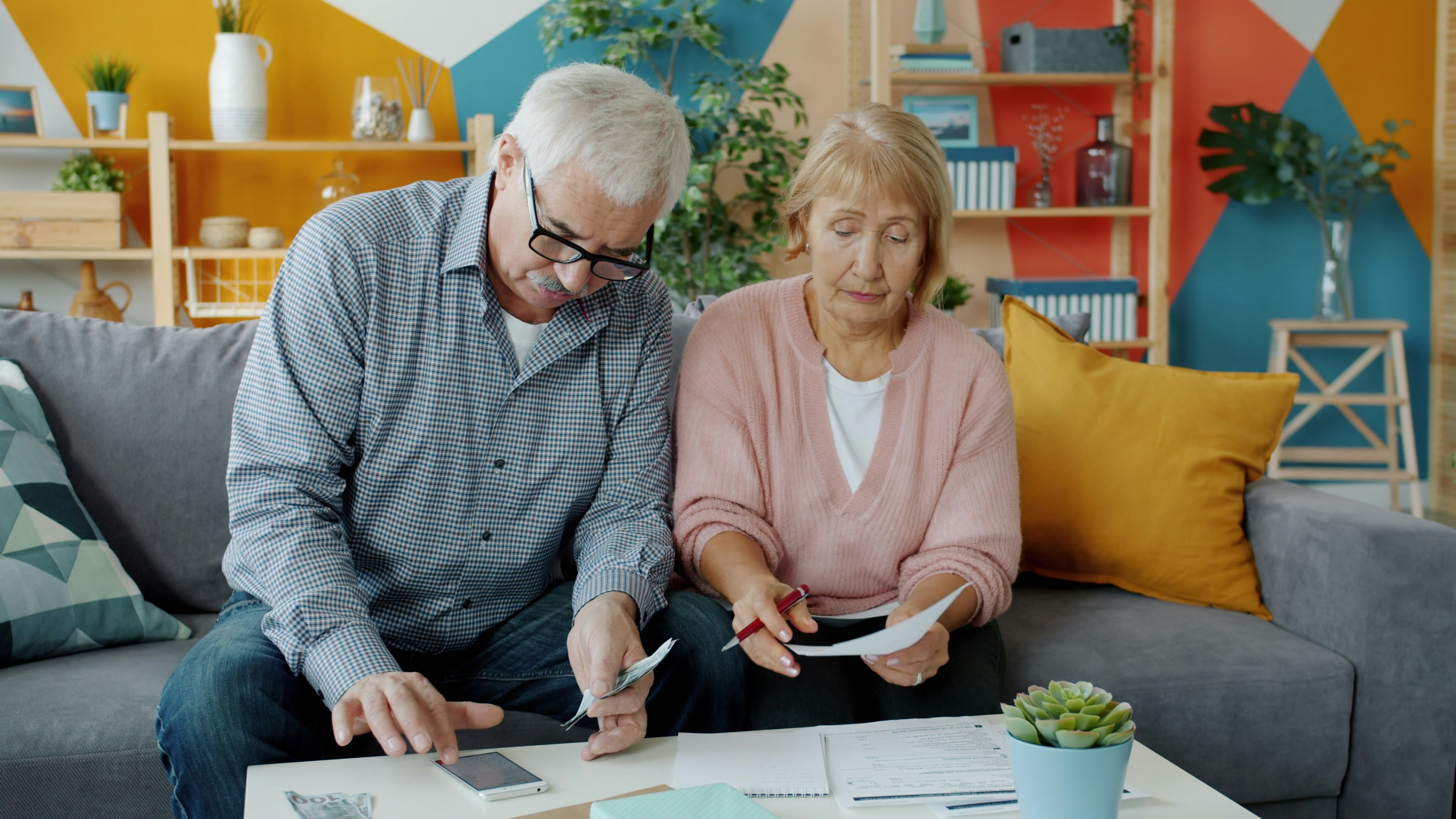 An older couple reviewing paperwork together at home