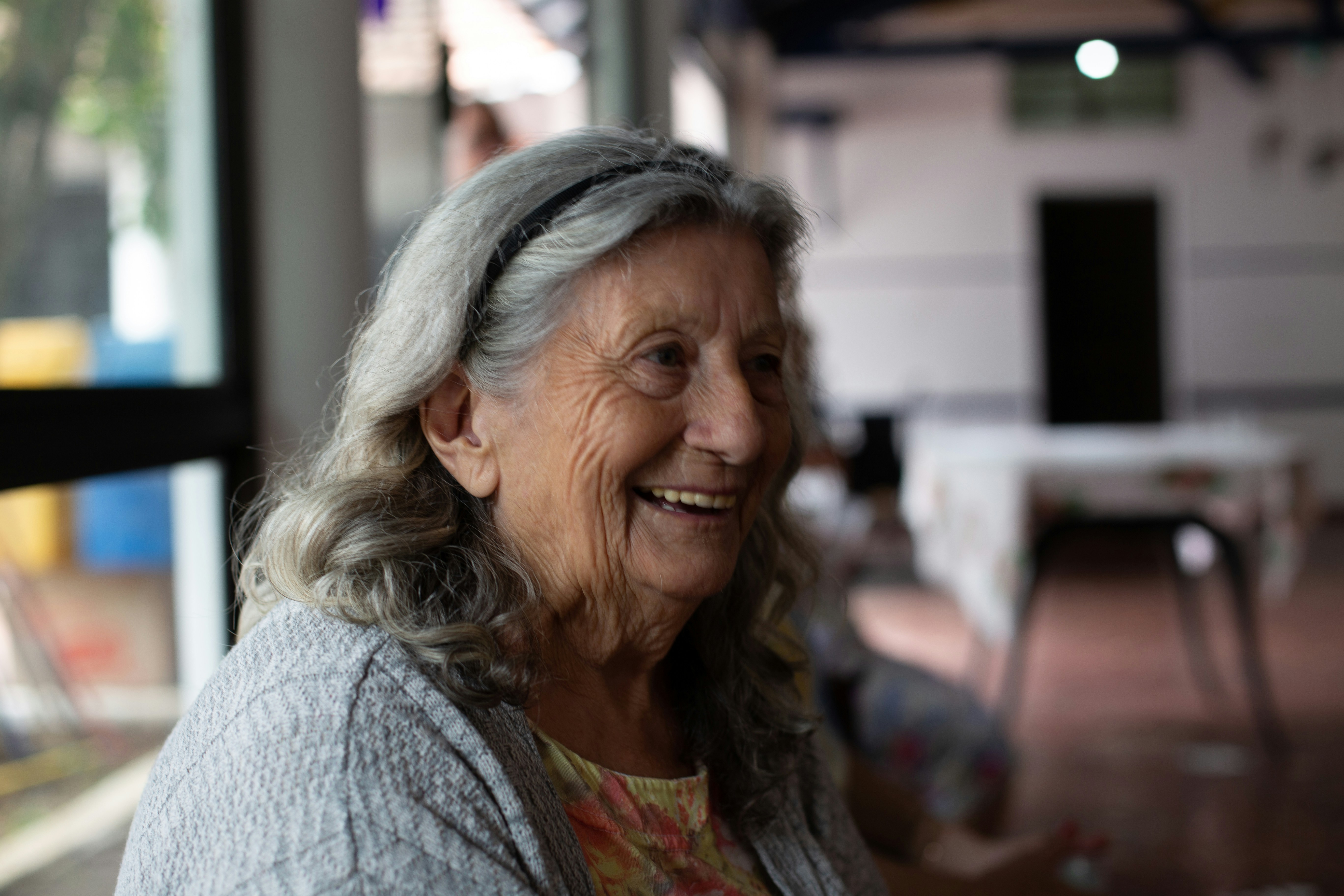 An older woman laughing in conversation